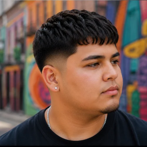 Mexican male model with French Crop Low Taper for round face, textured top and neat low taper sides.